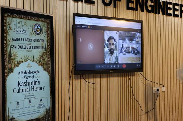 Dr. Haroon Rashid joining the seminar online beside the event standee